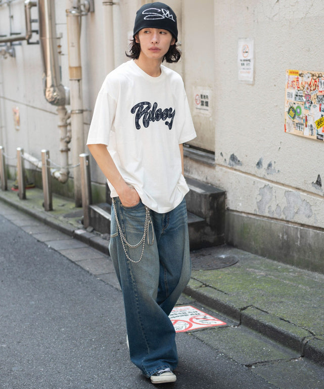 White oversized graphic T-shirt styled with faded baggy jeans